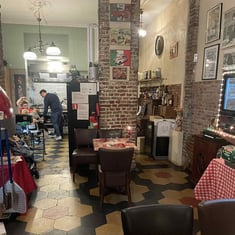 Warm, vintage-style interior of Shazanna pizzeria.