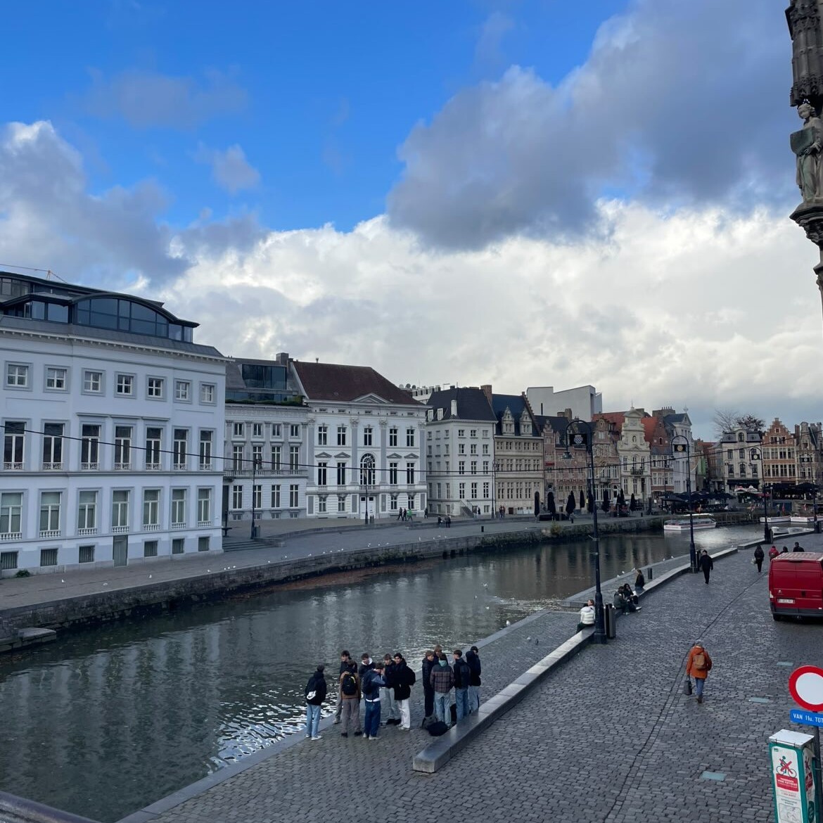 Korenlei and graslei. People are standing by the water on a cloudy day.
