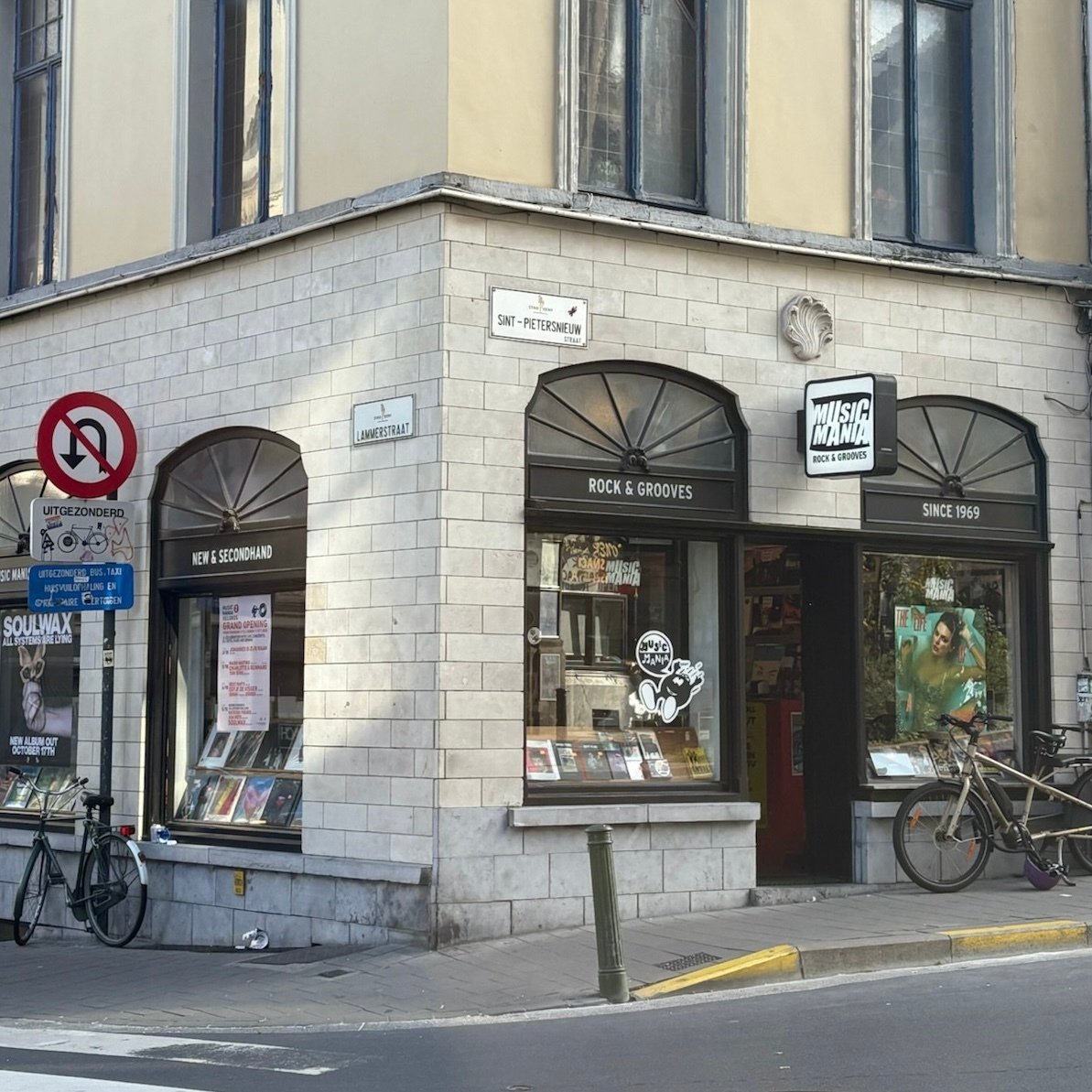 Outside of Music Mania store. Display has Vinyls and Books. Large Taylor Swift Poster on the window.