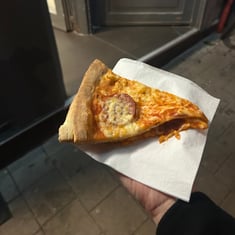 Pizza slice presented on a napkin