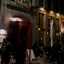 Exterior of Eat Love Pizza with a red, artsy-looking door