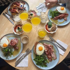 Brioche french toast with baked pear, bourbon cream, brownie and pecan and savory american pancakes with crispy bacon, fried eggs and maple syrup