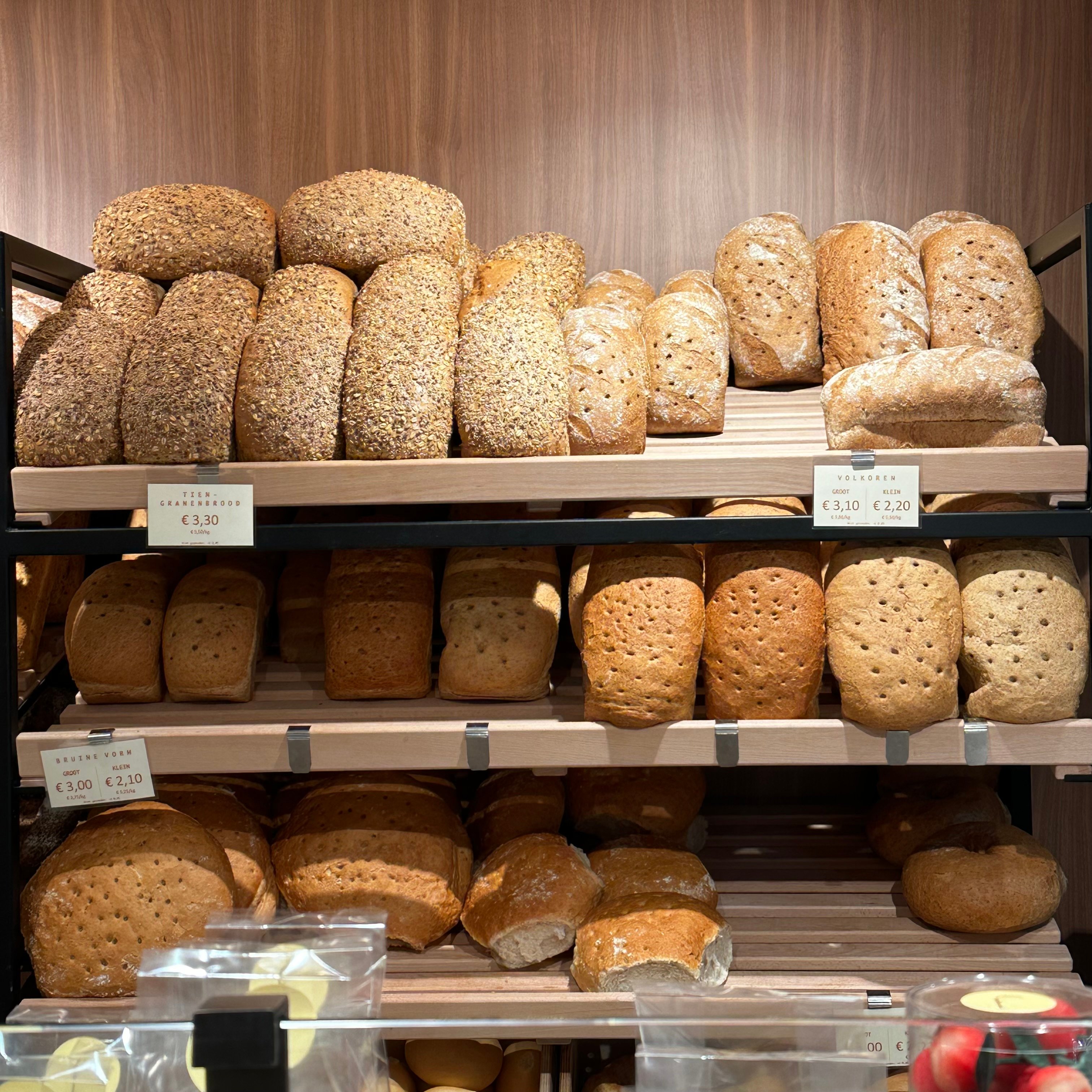 photo of bread on the shelves inside the bakery 