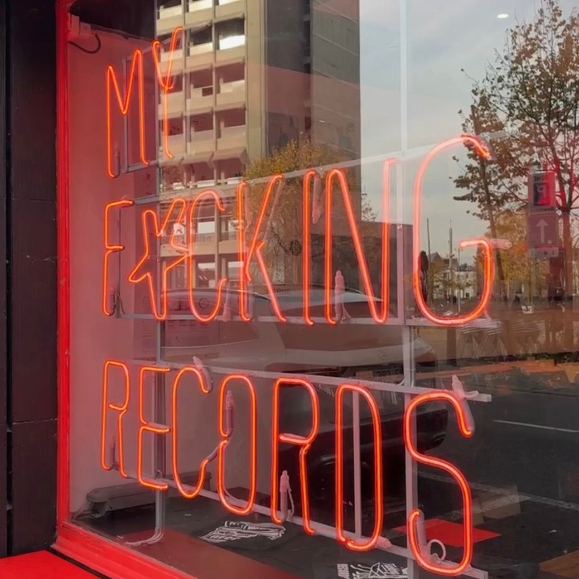 Red LED letters that spell "My fucking records" in the window