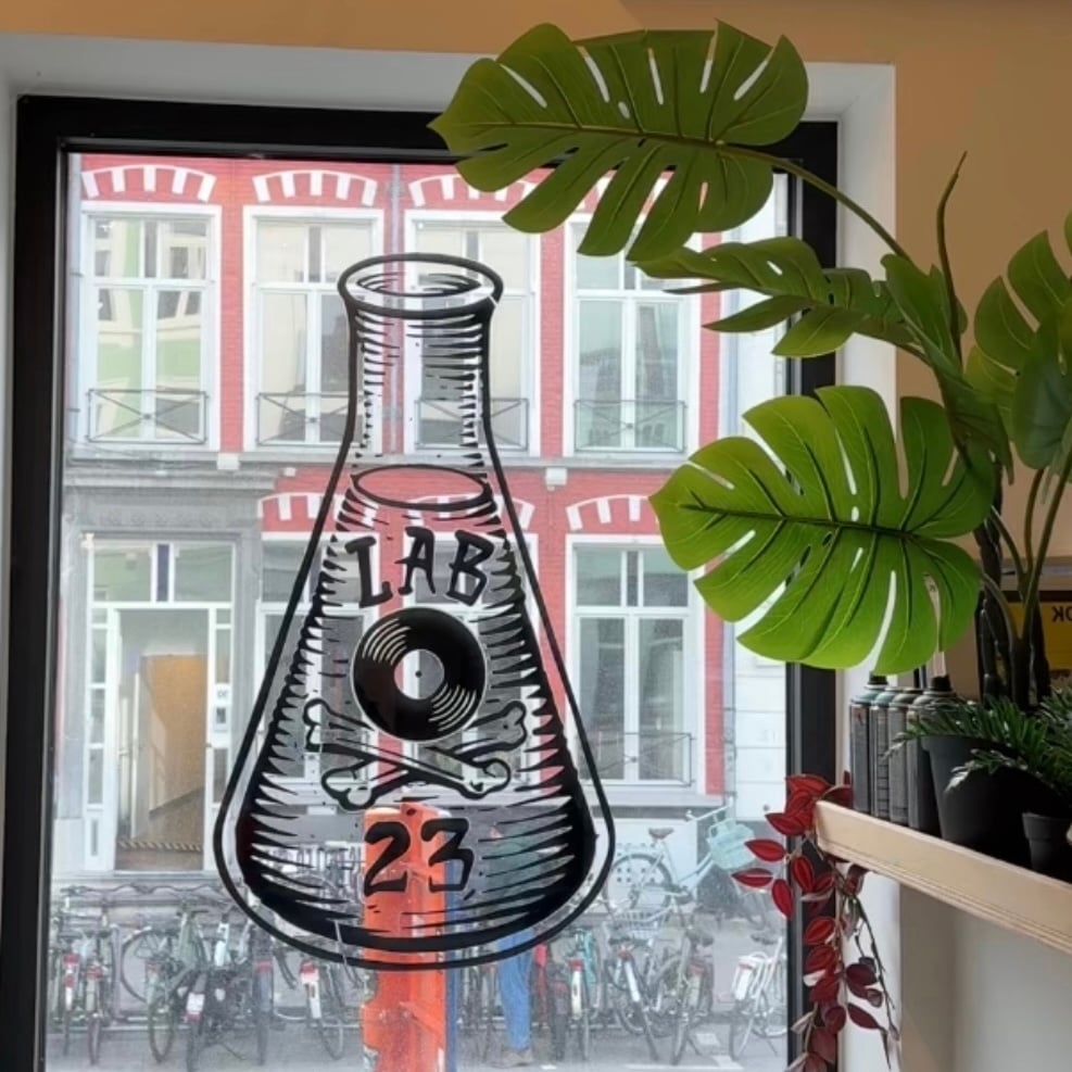 Logo on window with a bottle, vinyl and bones and 