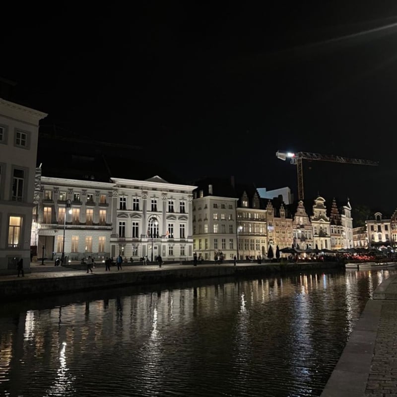 Night view of Graslei canal and historic buildings in Ghent