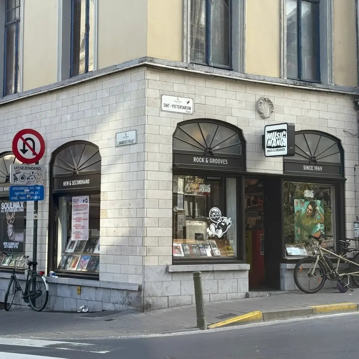 Outside of Music Mania store. Display has Vinyls and Books. Large Taylor Swift Poster on the window.