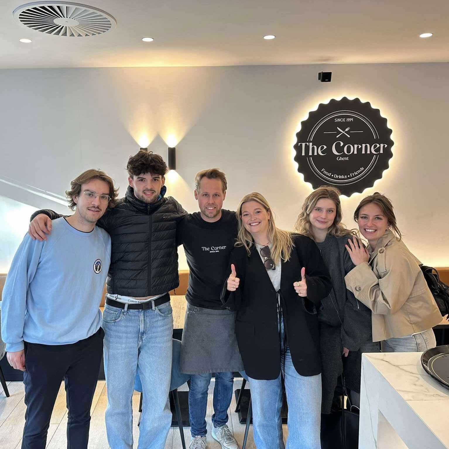 Six people standing in the middle of The Corner, a food and drink bar in Ghent.