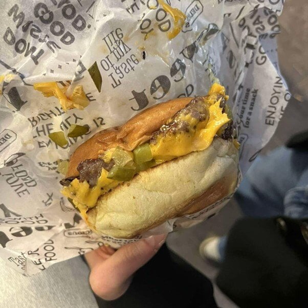 Close-up of a juicy smashburger with a crispy edge.