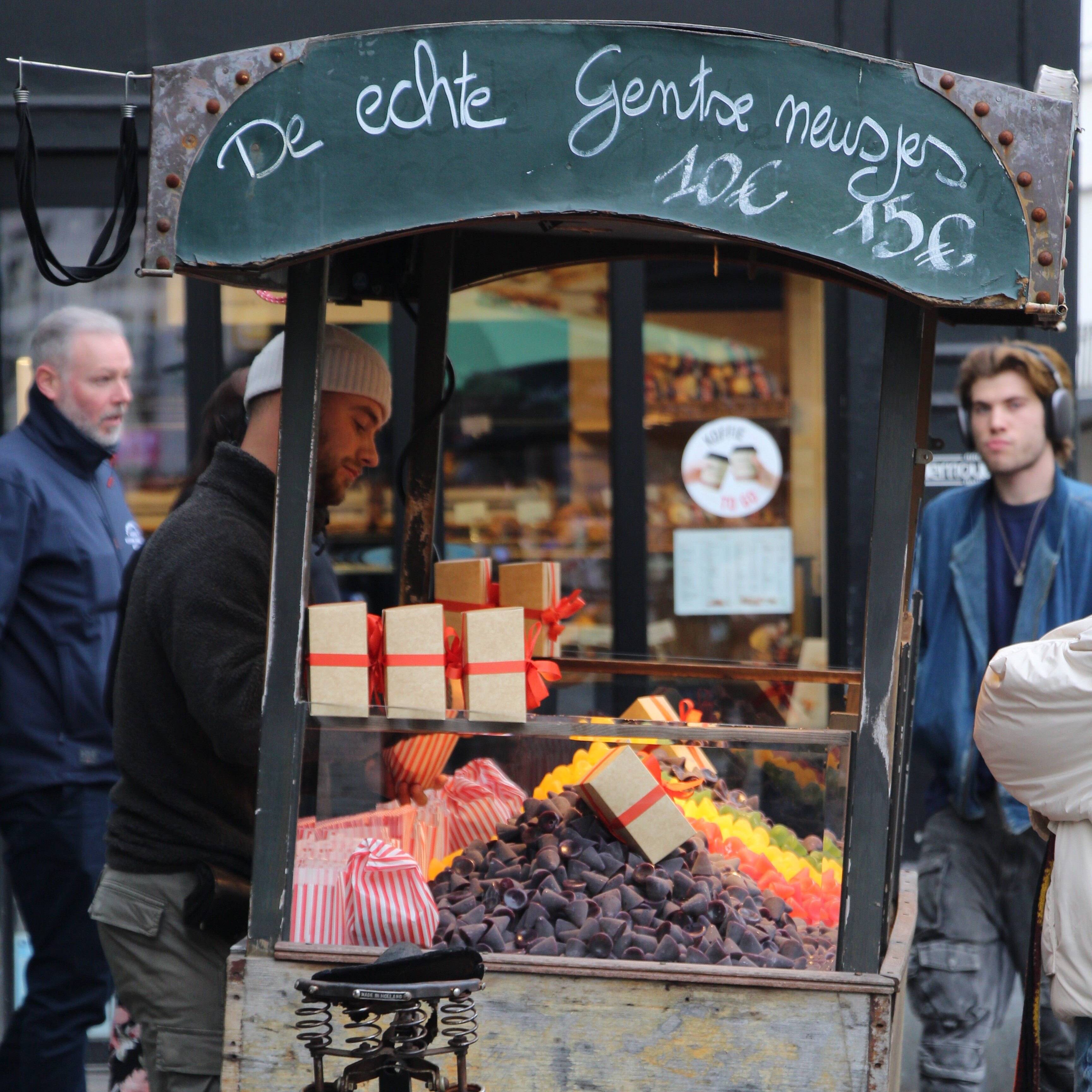 A market stall displaying purple cuberdons.