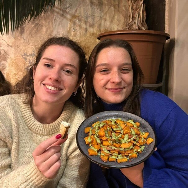 Friends holding plates of tapas in Malcontenta