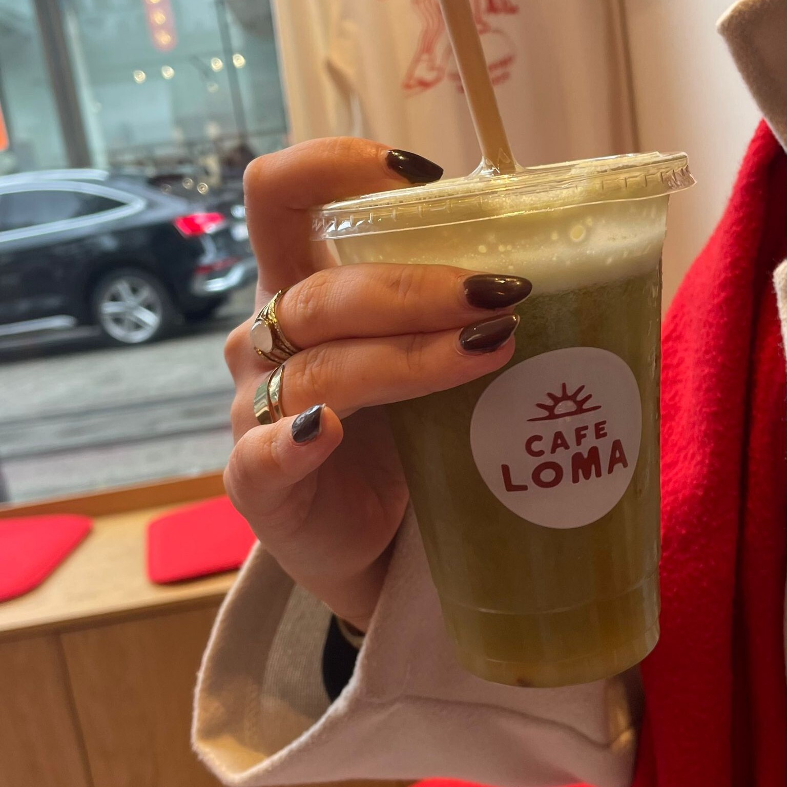 Someone holding a cup with the Loma juice