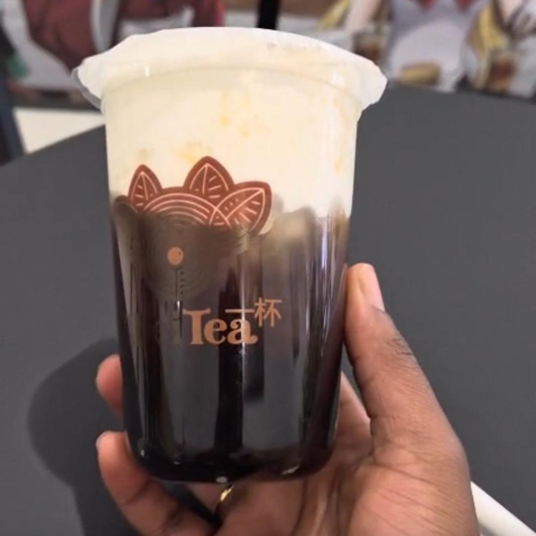 student holding a cheescake flavored bubble tea 